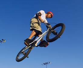 A young man catching air on a BMX bike